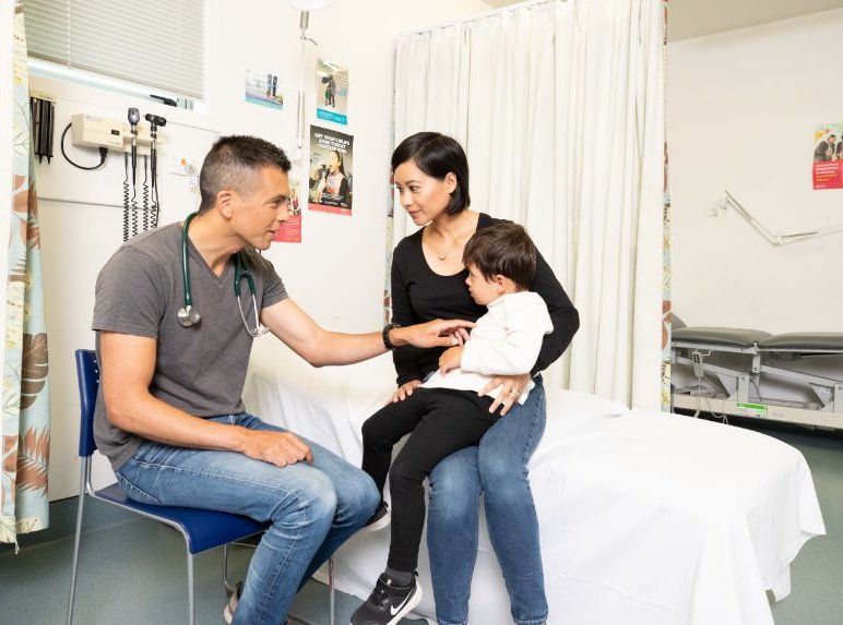 male doctor with woman and child