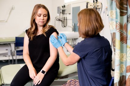 GP vaccinates young woman