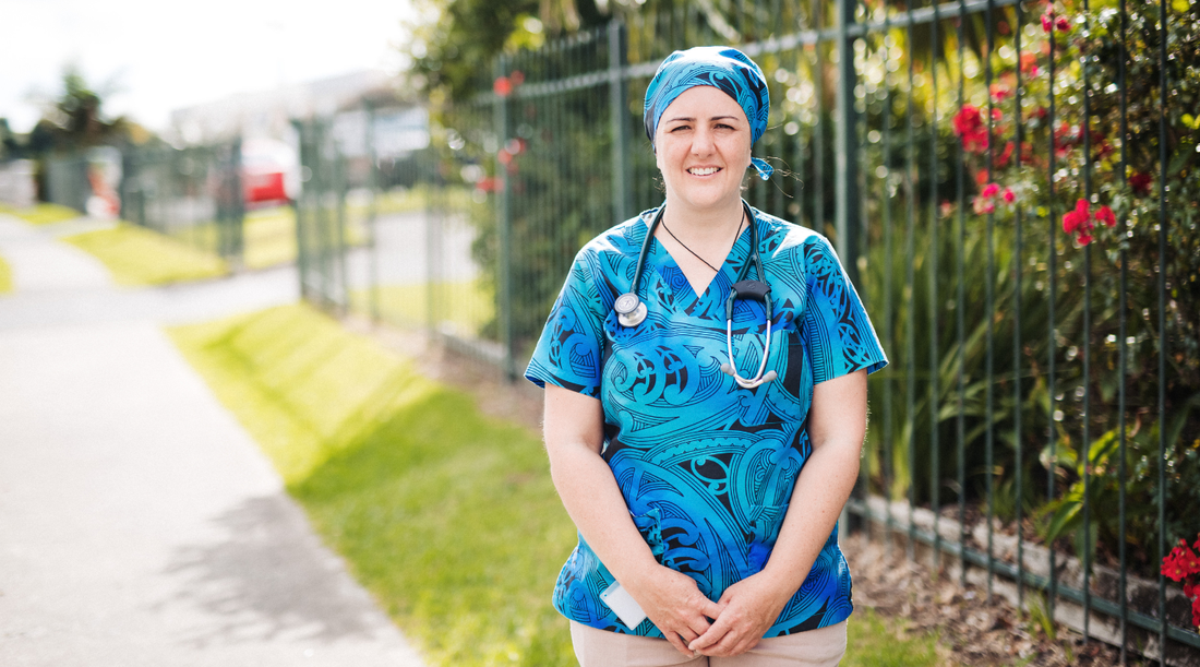 Dr Lily Fraser stands outside in a scrub top and cap