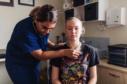 Dr Vanisi Prescott listens to a student's chest