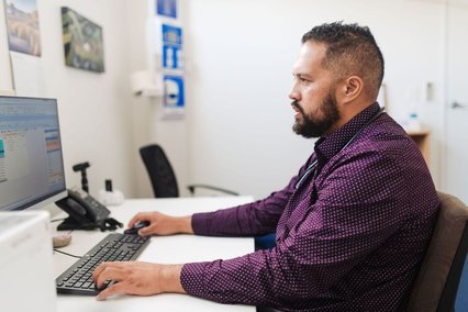 Dr Jason Tuhoe on the computer