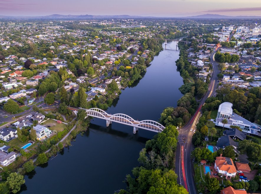 Aerial drone view at sunset of Hamilton City (Kirikiriroa) in the Waikato Region of New Zealand, Aotearoa stock photo