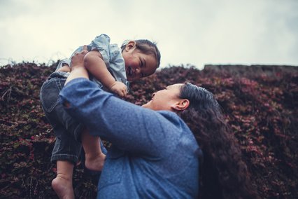 Maori mother plays with her child
